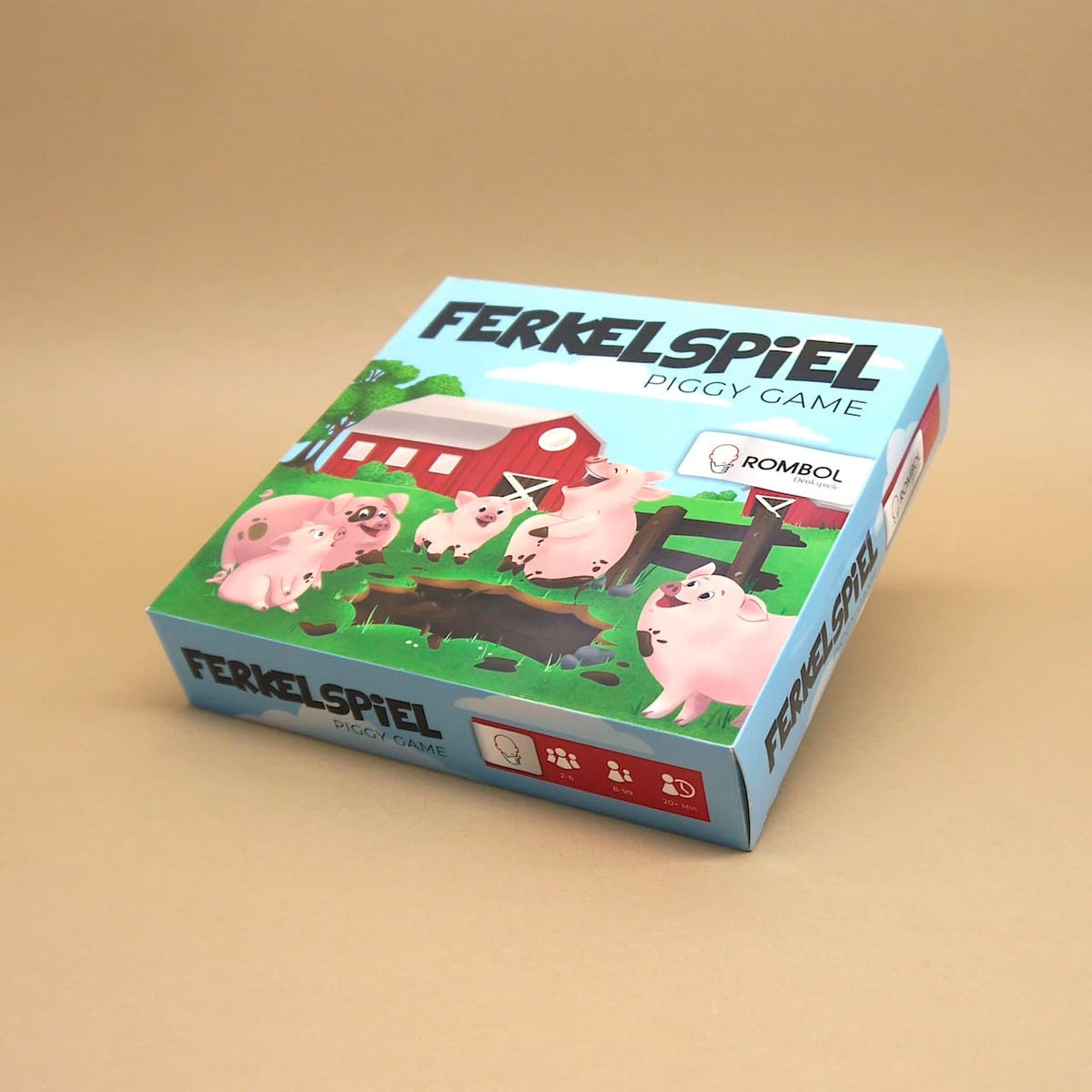 Schachtel des Ferkelspiels mit Cartoon-Schweinen vor einer Scheune – lädt ein zu unterhaltsamem Glücksspiel.