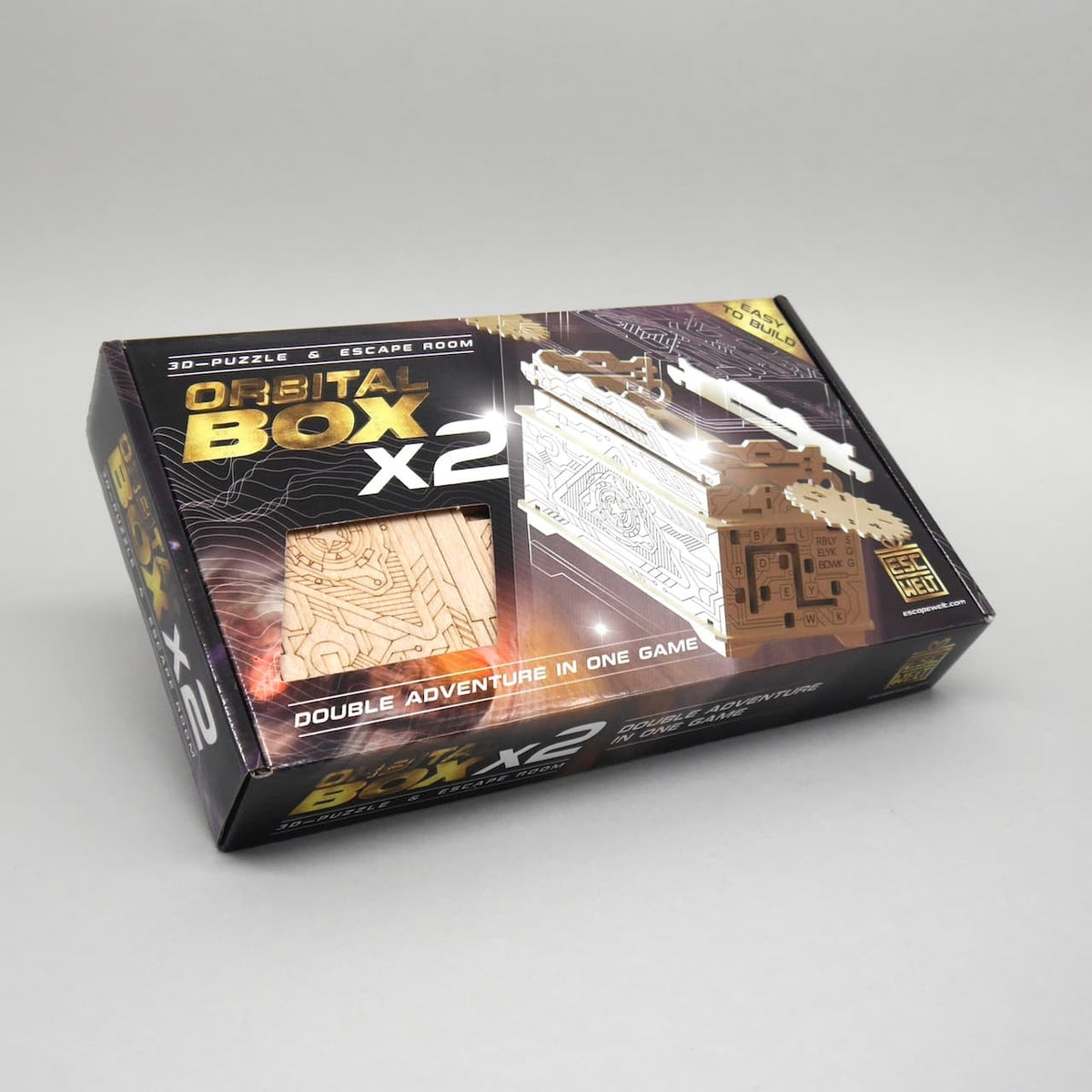 Verpackung der Orbital Box x2 mit sichtbarem Holzeinsatz, ein spannender Bausatz für Puzzle- und Escape-Room-Fans.