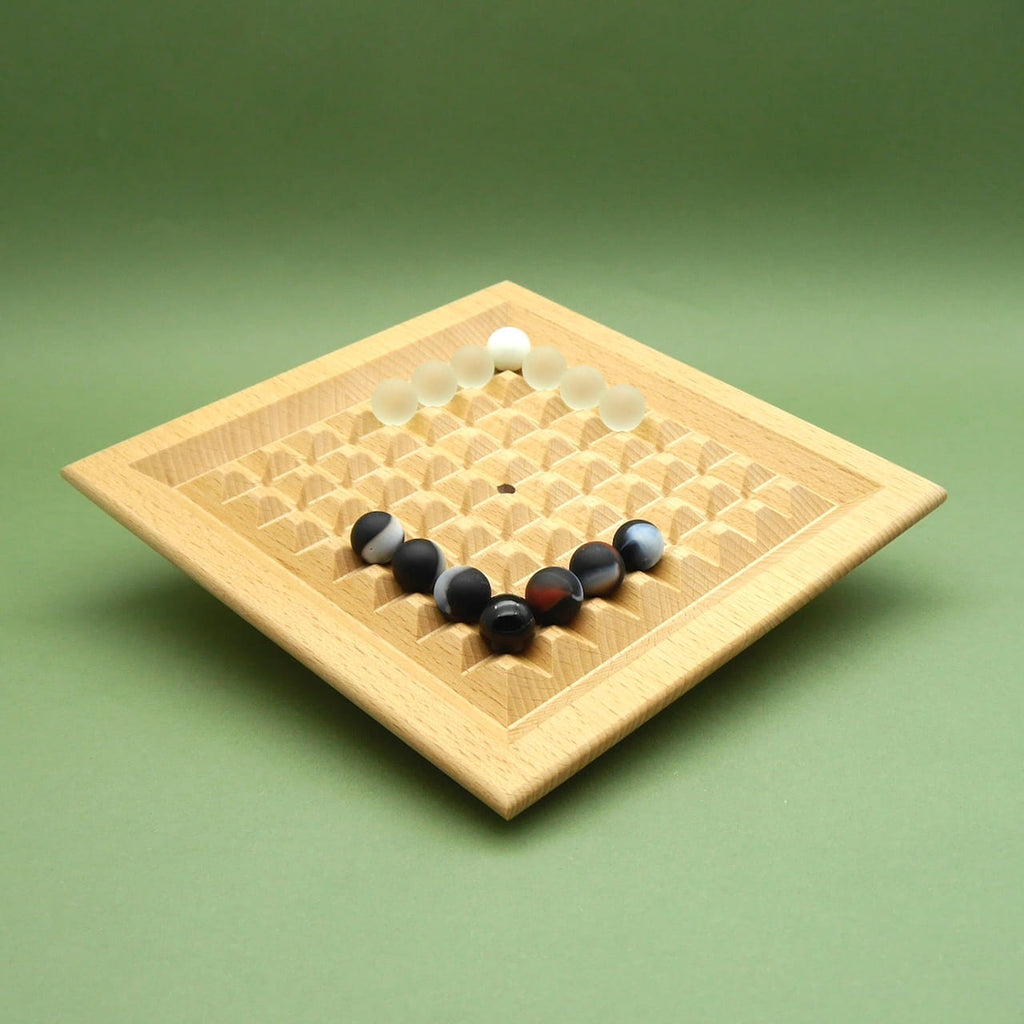 Holzbrett „90 Grad“ in Schrägansicht; helle und dunkle Steine bilden eine Ecke zum Mittelfeld hin – Taktikspiel.