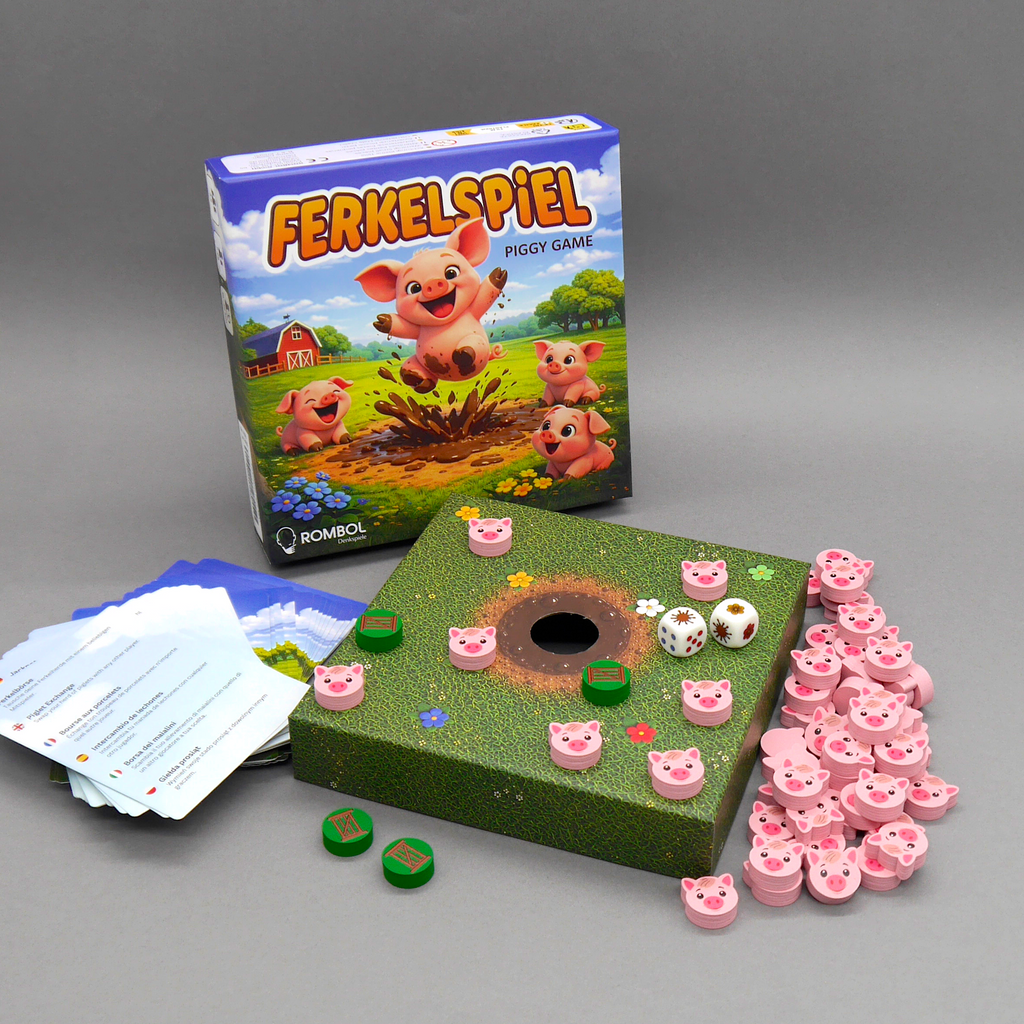 Ferkelspiel-Gesellschaftsspiel von Rombol: Spielschachtel, Spielplan mit Matschloch, Aktionskarten und rosa Ferkelfiguren sind arrangiert.
