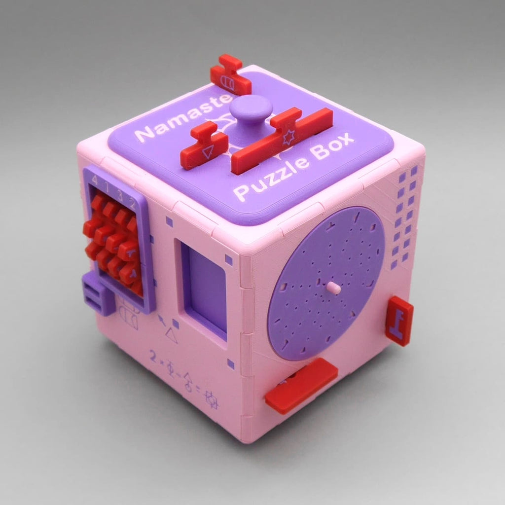 Rosa-lila Namaste Puzzle Box XL mit Reglern und Scheiben, ein 3D-Puzzle als kreative Geschenkidee für Denksport-Fans.