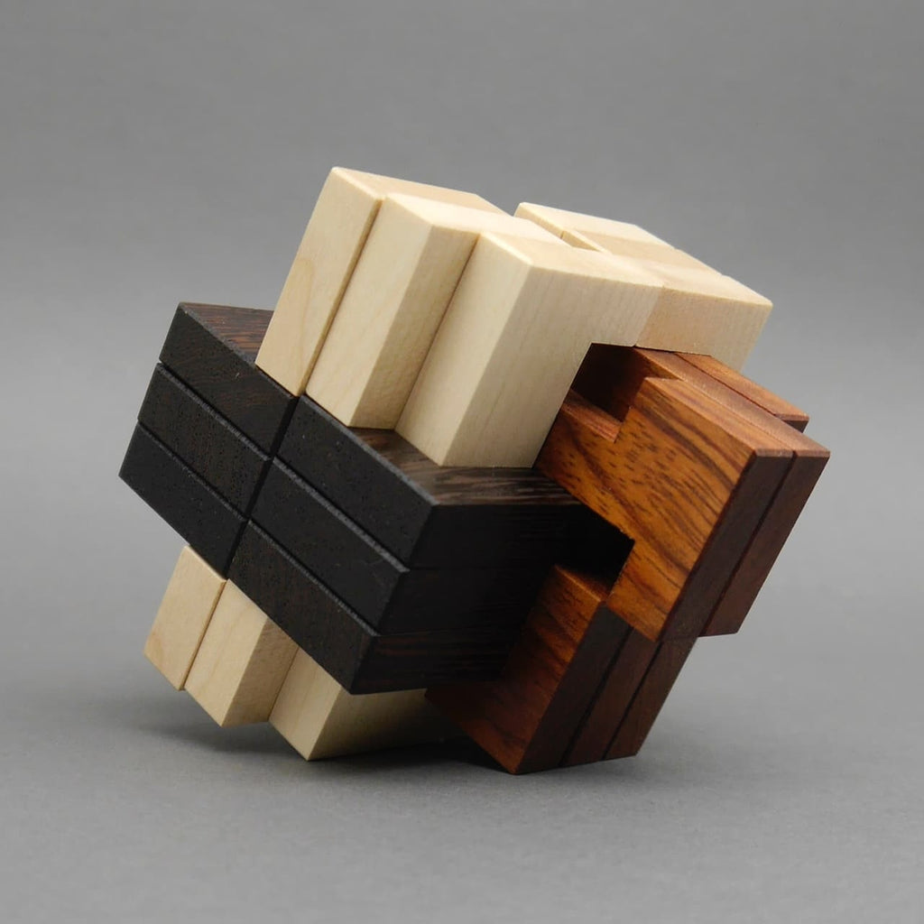 Dreidimensionales Holzpuzzle aus hellen, dunklen und rötlichen Teilen zur Förderung von Gehirntraining und Logik.
