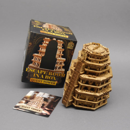 Quest Tower neben der geöffneten Geschenkverpackung mit Anleitung.