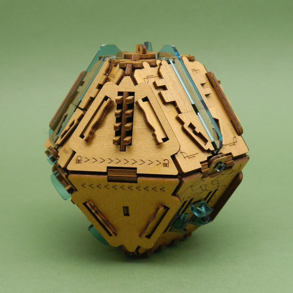 Knobelbox Stein der Weisen: hölzerner Brainteaser/Knobelspiel mit Gravuren und blauen Acryl-Elementen auf grünem Hintergrund.