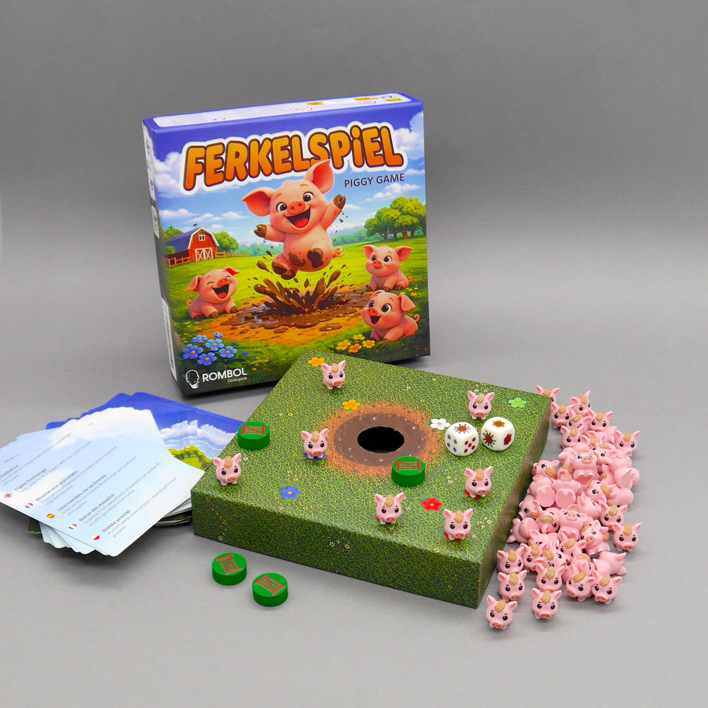 Komplettes Ferkelspiel-Gesellschaftsspiel ausgebreitet: Schachtel, Wiesenplan mit Matschloch, Aktionskarten und viele rosa Ferkel.