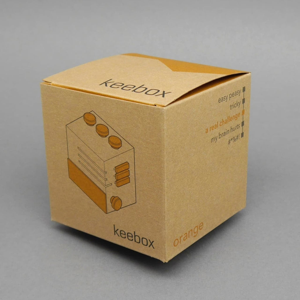 Braune Verpackung mit Zeichnung der Keebox; Knobelbox in der Variante Orange.